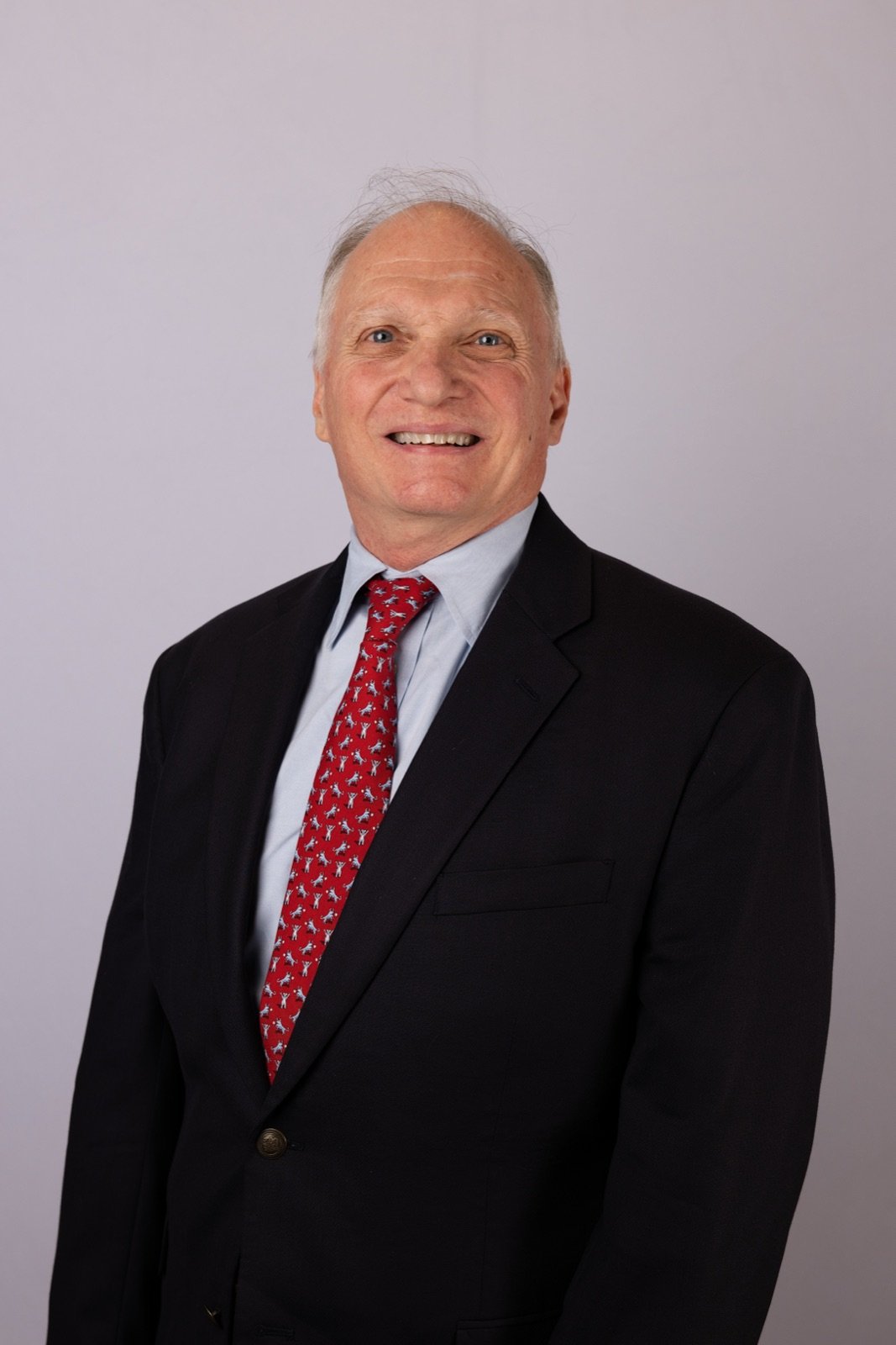 Skip York, strategist and keynote speaker, in a navy suit and red tie